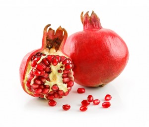 Ripe Sliced Pomegranate Fruit with Seeds Isolated on White